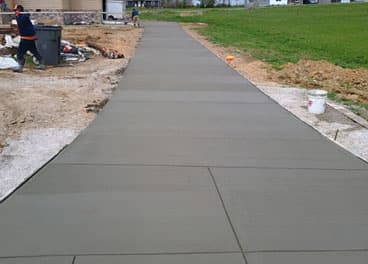 New concrete driveway and walkway poured at a residential construction site in Lawrence County, TN