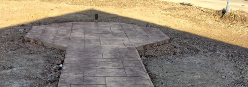Stamped concrete front walkway and entry pad with stone pattern at a new home in Tennessee